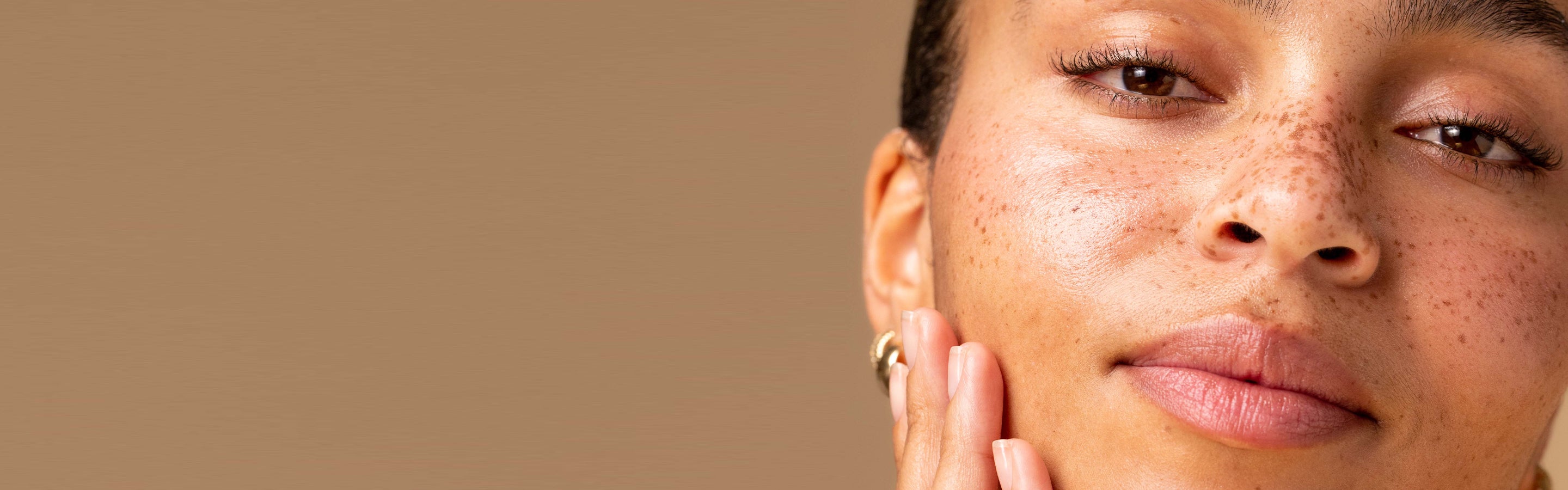 Model close up touching her cheeck