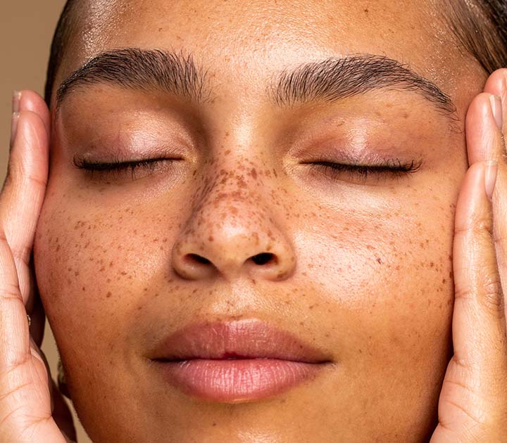 Model touching her face close up