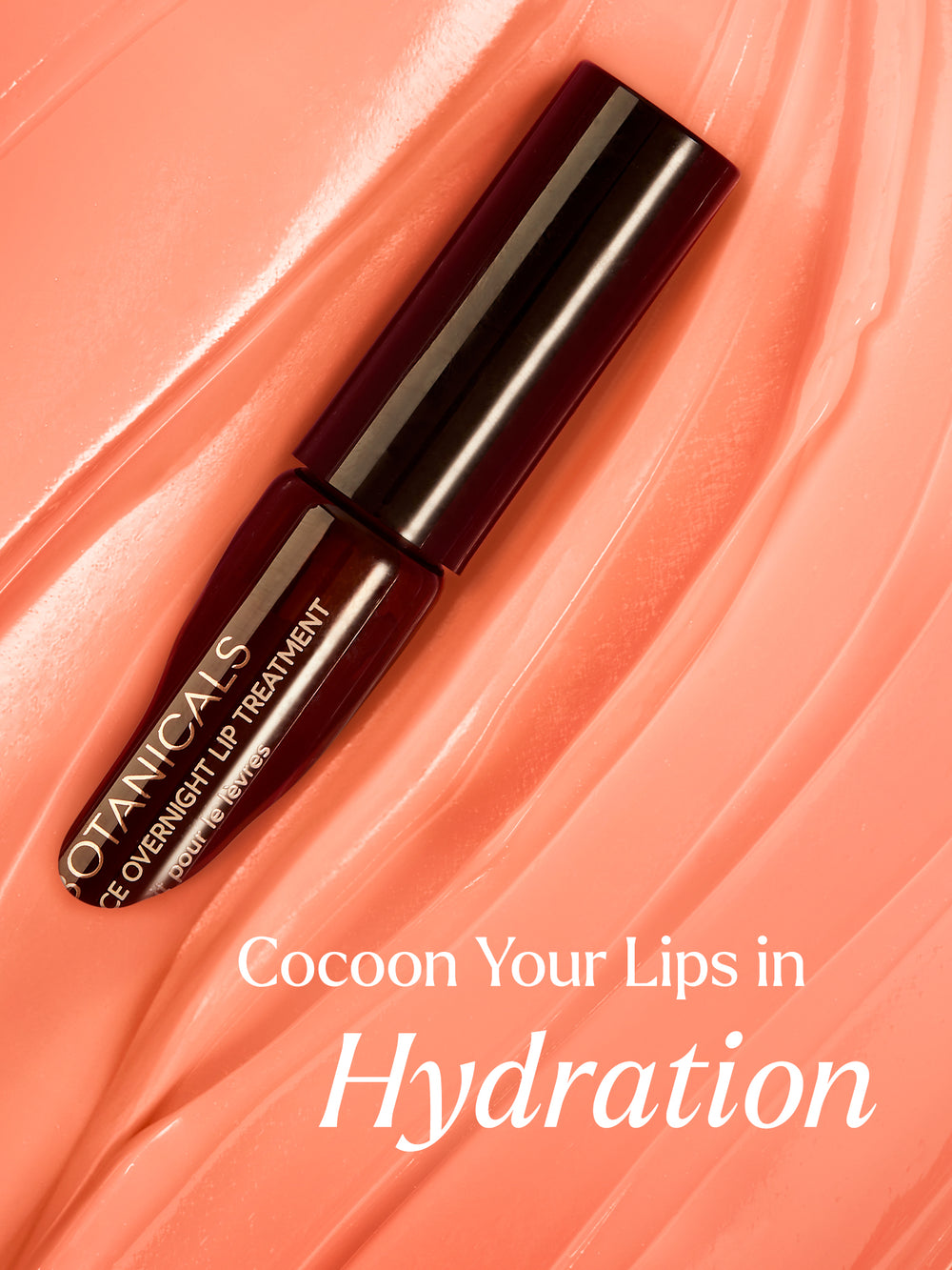 The image features True Botanicals' Pure Radiance Overnight Lip Treatment presented against a backdrop of smooth, glossy pink textures that mimic the appearance of hydrated lips. The text "Cocoon Your Lips in Hydration" emphasizes the product's nourishing and moisturizing benefits. The luxurious, deep maroon packaging contrasts beautifully with the soft pink tones, highlighting the product's premium appeal. This composition evokes a sense of indulgence and care.